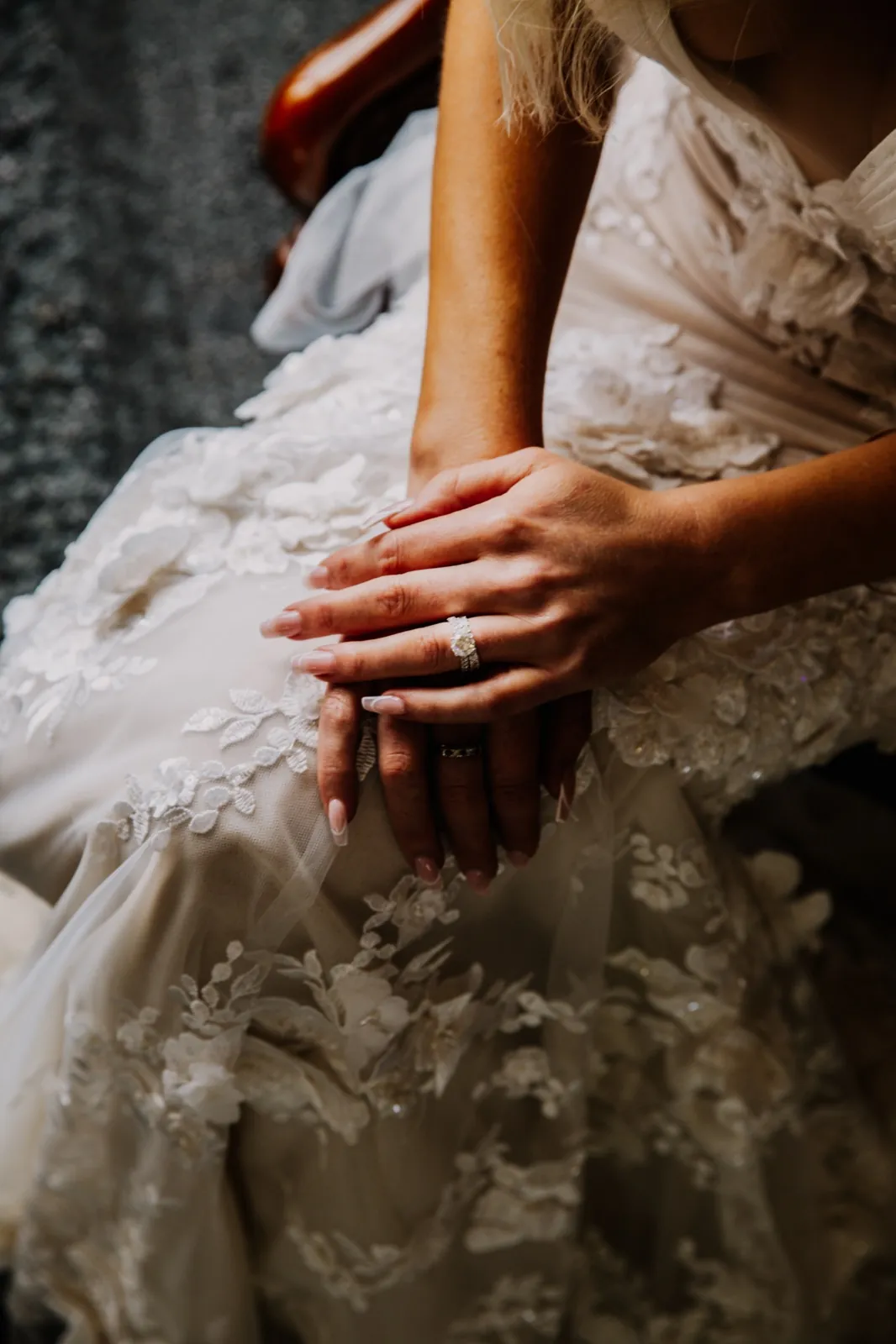 Close-up of the bride's hands and ring on lace