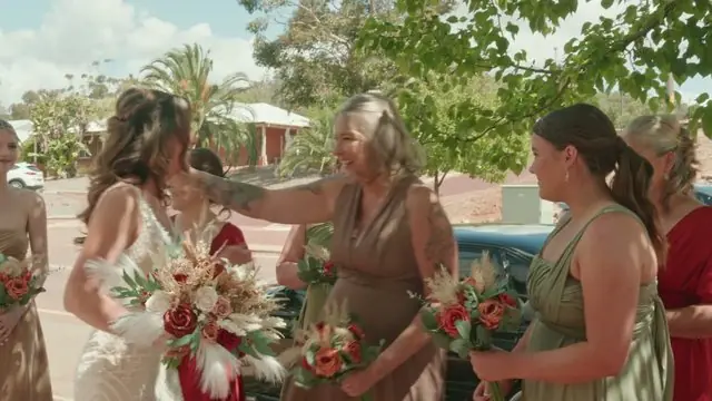 Wedding film still: bridesmaids laughing together before the ceremony