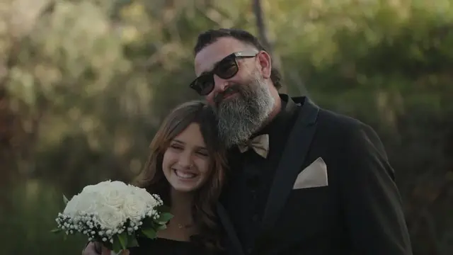 Wedding film still: couple close together in warm afternoon light