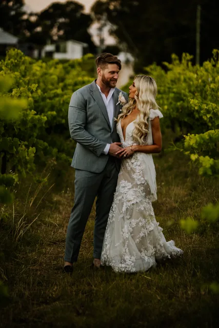 Couple embracing between the vine rows