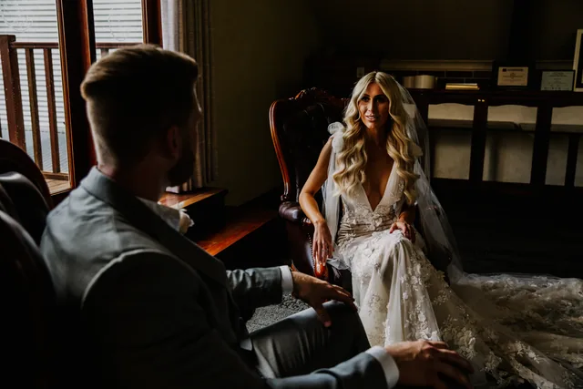 Bride seated indoors as the evening reception begins