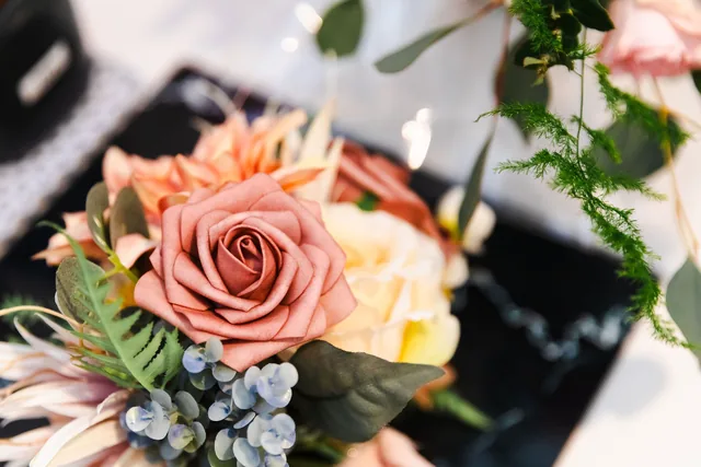 The bouquet — peach roses, blue thistle and native foliage