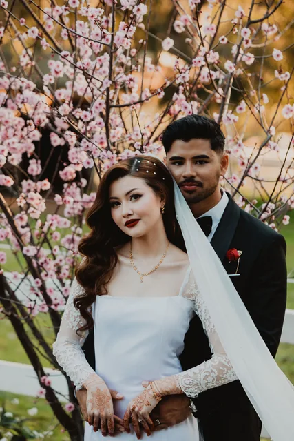The couple beneath the spring blossom at Brookleigh Estate