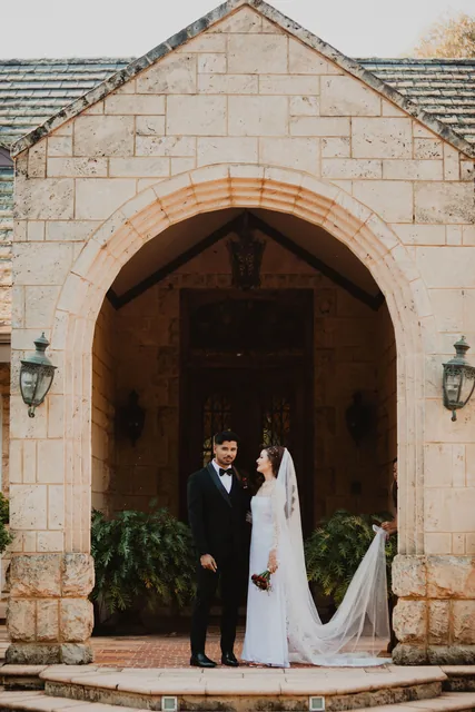 The couple framed in the Chateau’s limestone archway