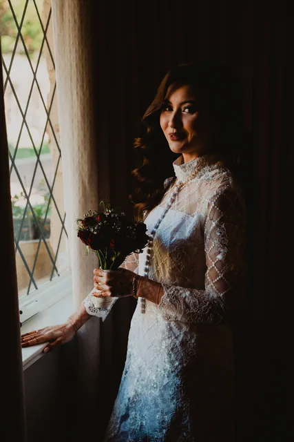 The bride in profile at the leaded window