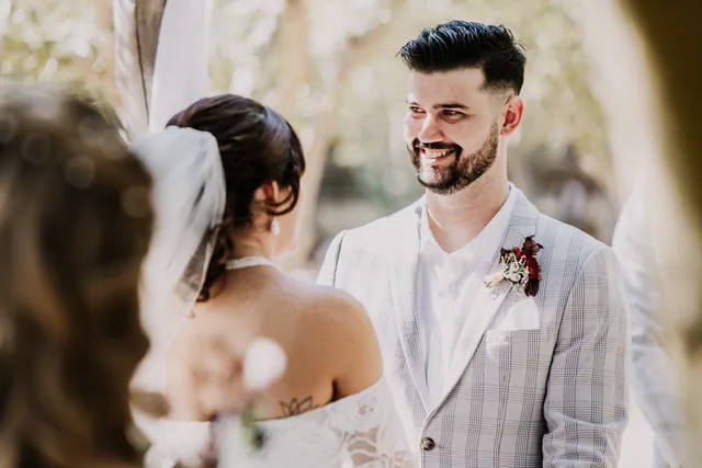 Bride and groom smiling at each other after the ceremony