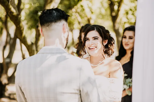 Bride smiling at her groom during the ceremony