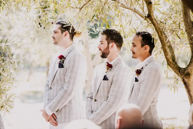 Groom and groomsmen watching the ceremony